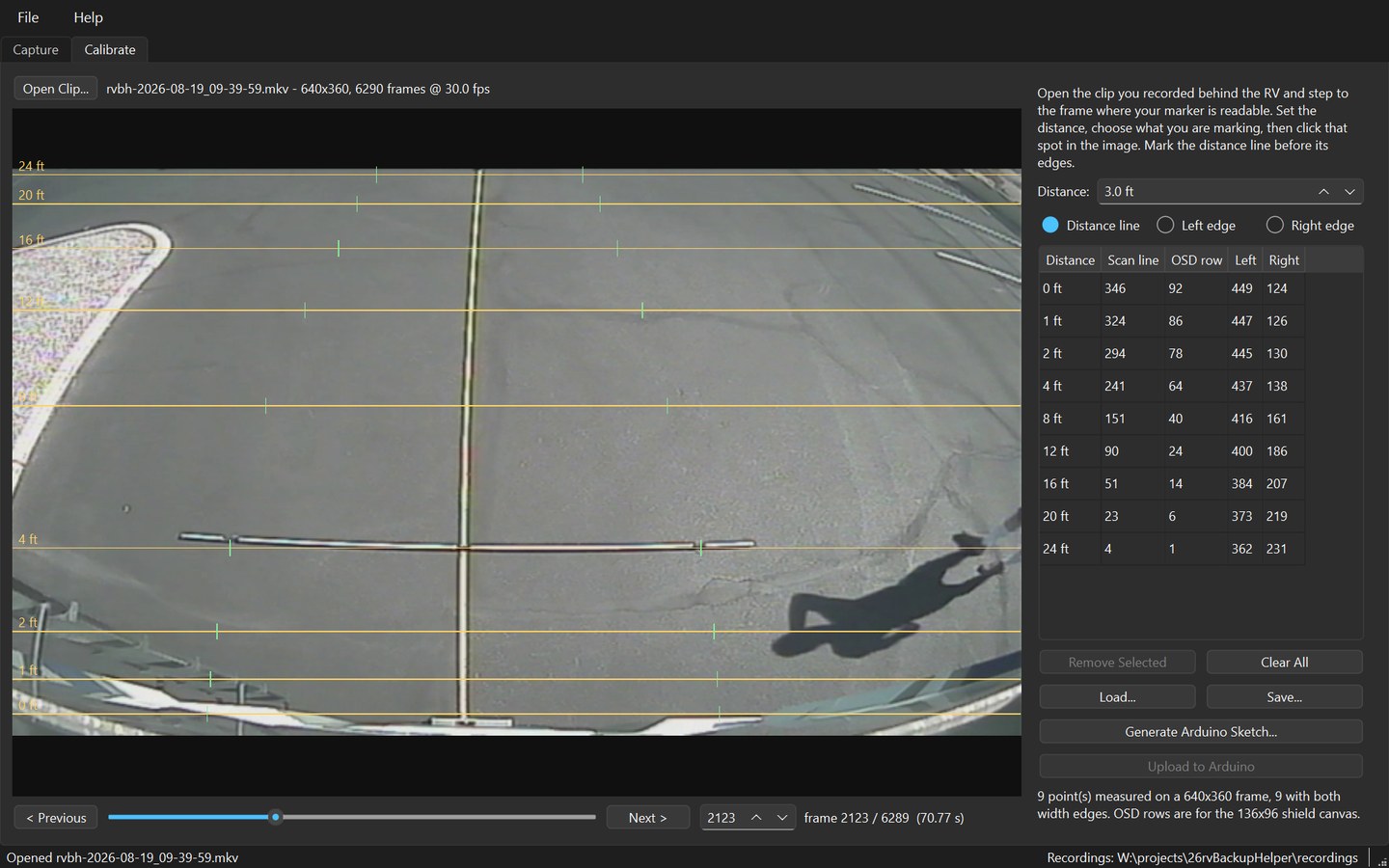A finished calibration: amber guide lines labelled 0 to 24 feet across the picture, green width ticks on each, and a filled table listing distance, scan line, OSD row and both edges